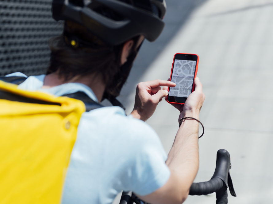 Man on bike with smartphone map app