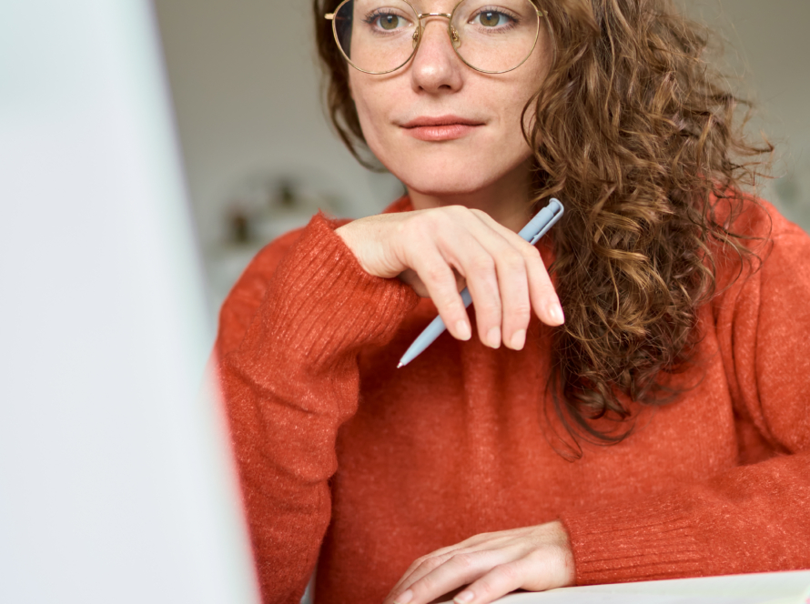 Young woman using laptop looking at computer elearning watching webinar.